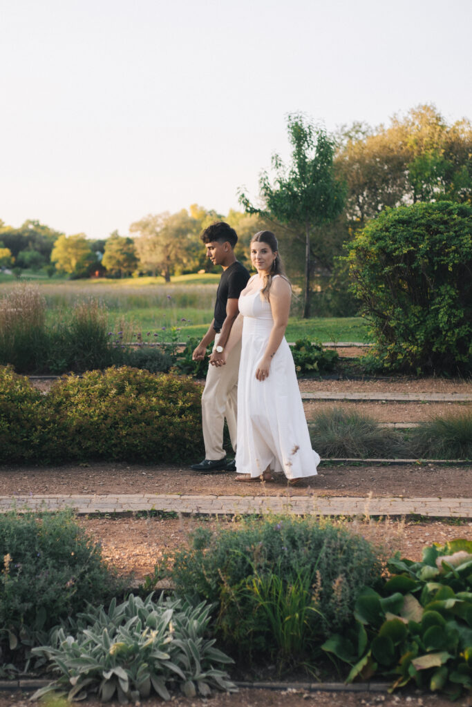 Couple walking through park while holding hands at Kings Park