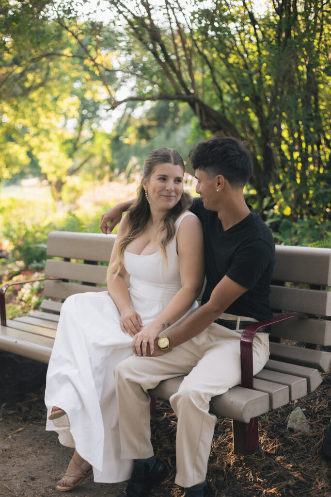 Couple sitting on bench at Kings Park in Winnipeg