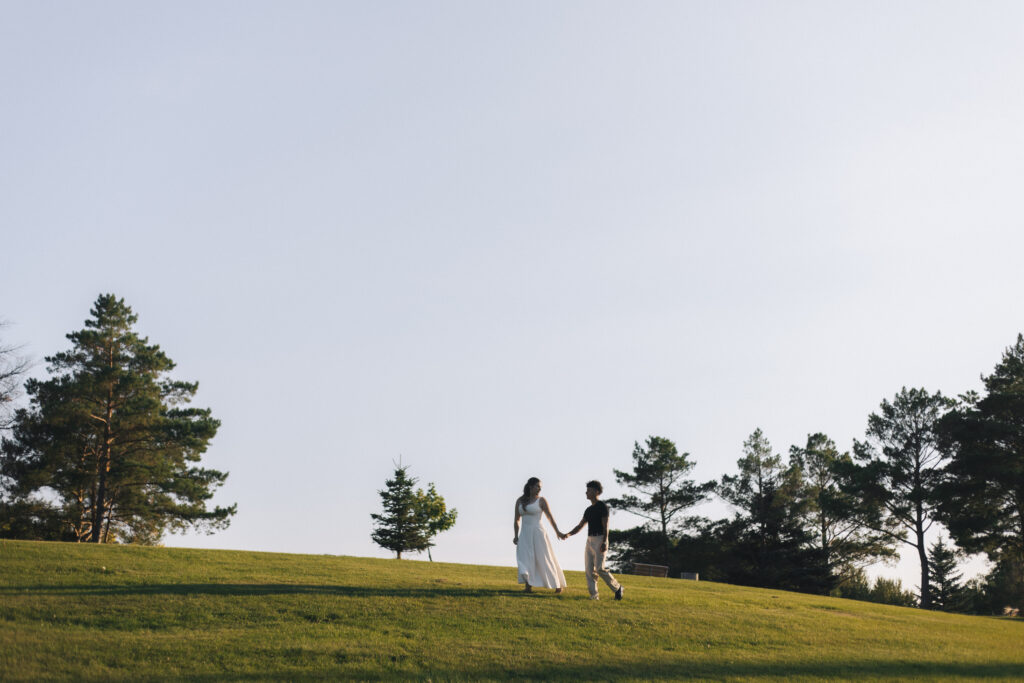 Couple walking across a hill at Kings Park in Winnipeg Manitoba