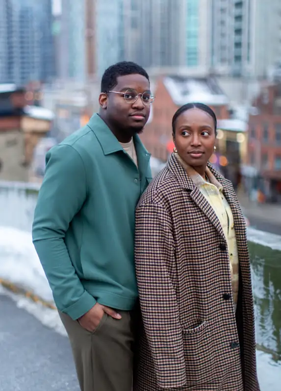 A romantic portrait of a couple celebrating their anniversary with the Ottawa skyline and Parliament Hill visible in the background during the blue hour.